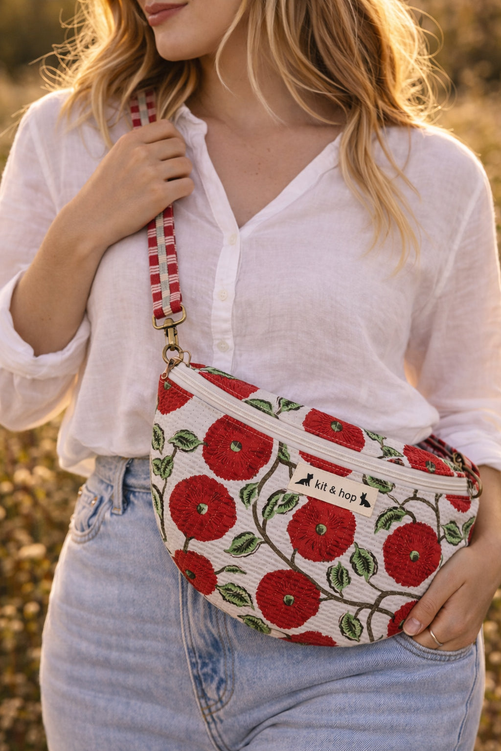 Handmade cross body bag Elara in Poppy pattern, worn by a woman in a field, perfect for everyday use.