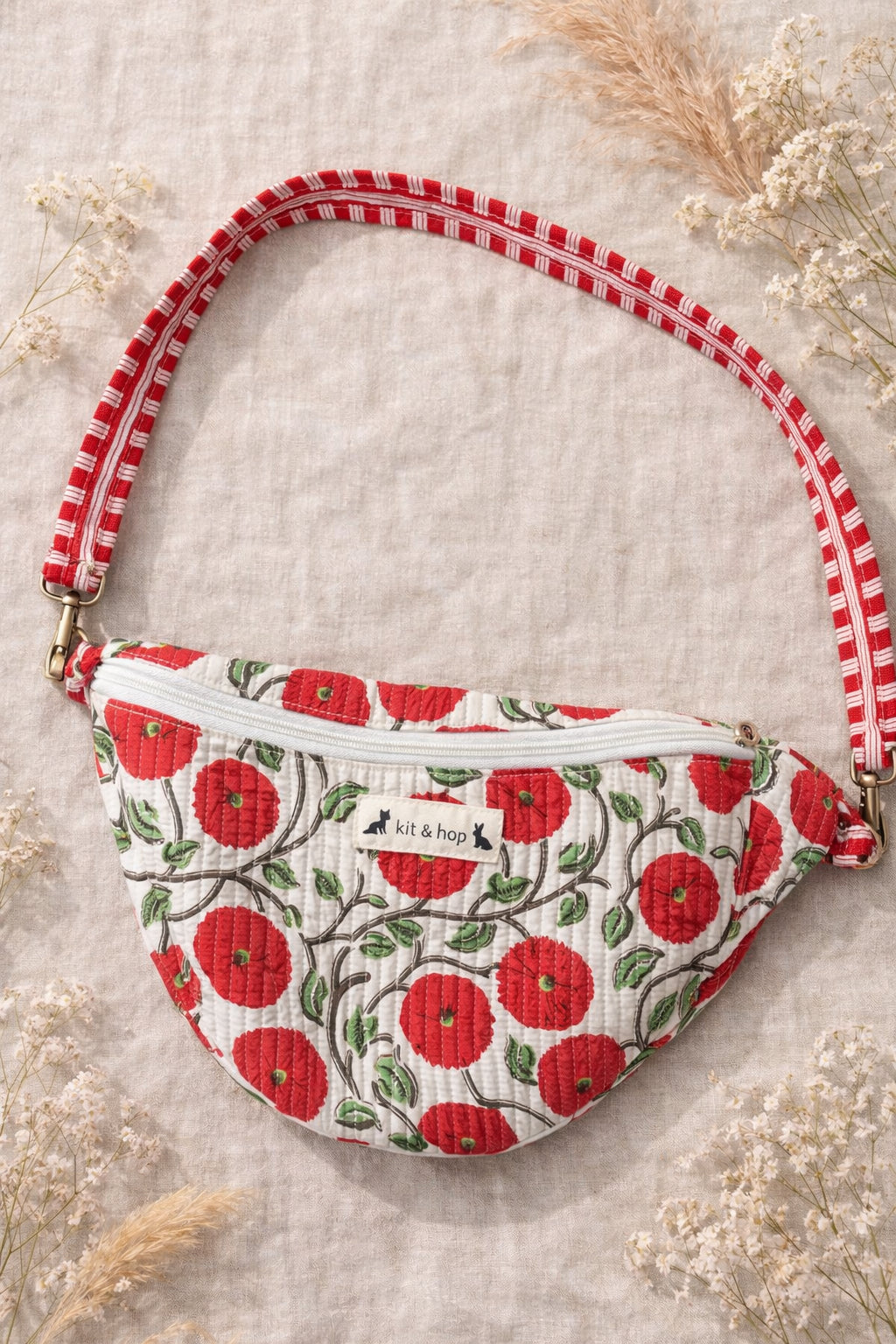 Handmade cross body bag Elara in Poppy pattern, worn by a woman in a field, perfect for everyday use.