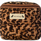 Handmade cross body bag Elara Wildflower Path in LEOPARD PRINT worn by woman in a field.