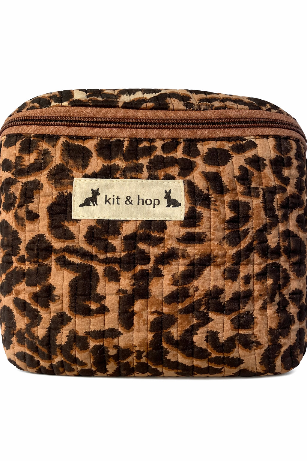 Handmade cross body bag Elara Wildflower Path in LEOPARD PRINT worn by woman in a field.