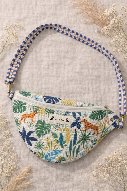 Handmade cross body bag Elara Wildflower Path in ANIMAL PRINT worn by woman in a field.