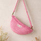 Handmade cross body bag Elara in pink gingham worn by a woman outdoors in a sunny field.