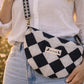 Handmade cross body bag Elara Wildflower Path in noir check worn by woman in a field.