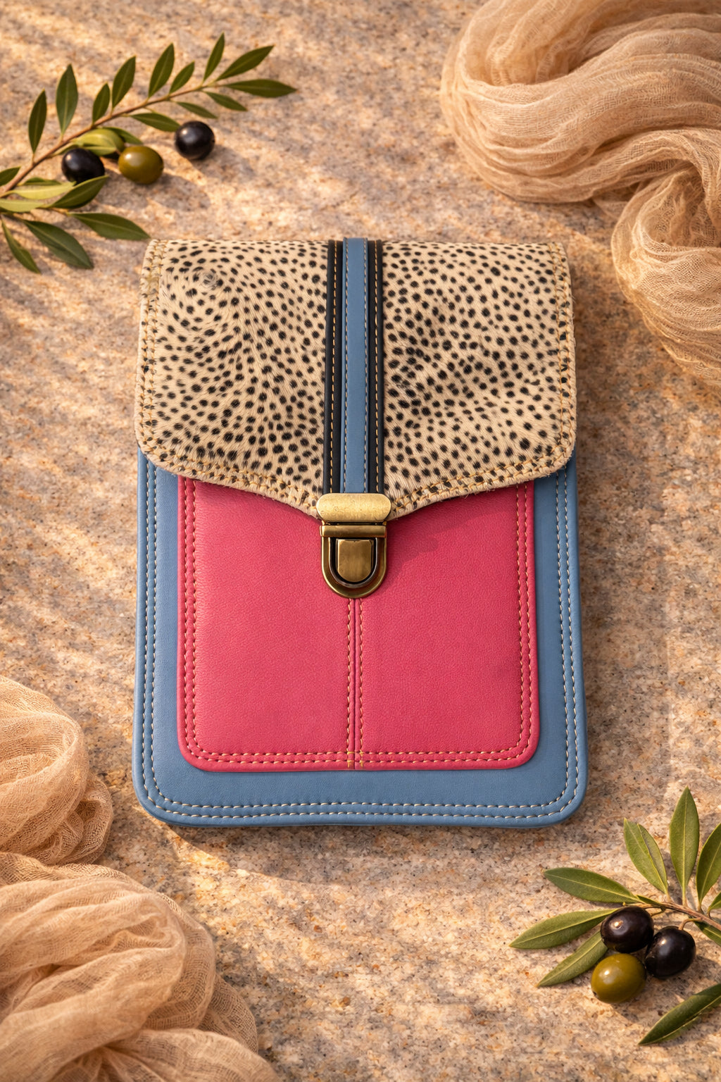 Handmade Leather Crossbody Bag with pink and blue design, featuring a spotted flap and a stylish closure.