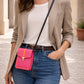 Handmade Leather Crossbody Bag in vibrant pink and orange tones, set against a textured background with greenery.