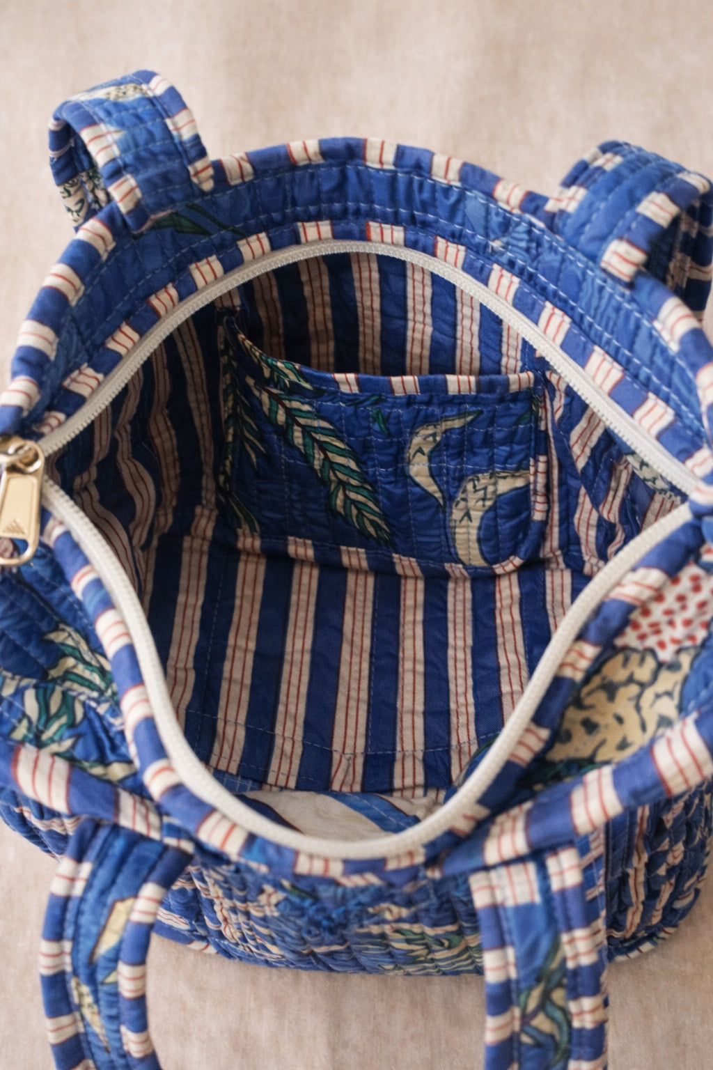 Handmade Cotton Mini Tote Bag - Lila - Wild Meadow - Indigo hanging on a wooden hook with decorative flowers.