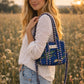 Handmade Cotton Mini Tote Bag - Lila - Wild Meadow - Indigo hanging on a wooden hook with decorative flowers.