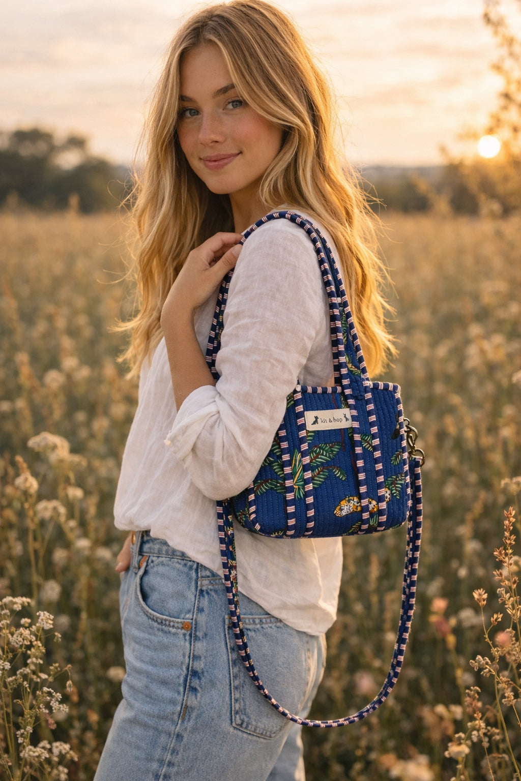 Handmade Cotton Mini Tote Bag - Lila - Wild Meadow - Indigo hanging on a wooden hook with decorative flowers.