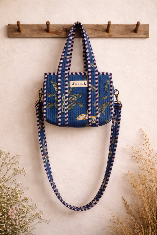 Handmade Cotton Mini Tote Bag - Lila - Wild Meadow - Indigo hanging on a wooden hook with decorative flowers.