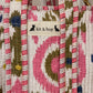 Handmade Cotton Mini Tote Bag - Lila - Wild Meadow - Arlo displayed on a wall with floral decor.
