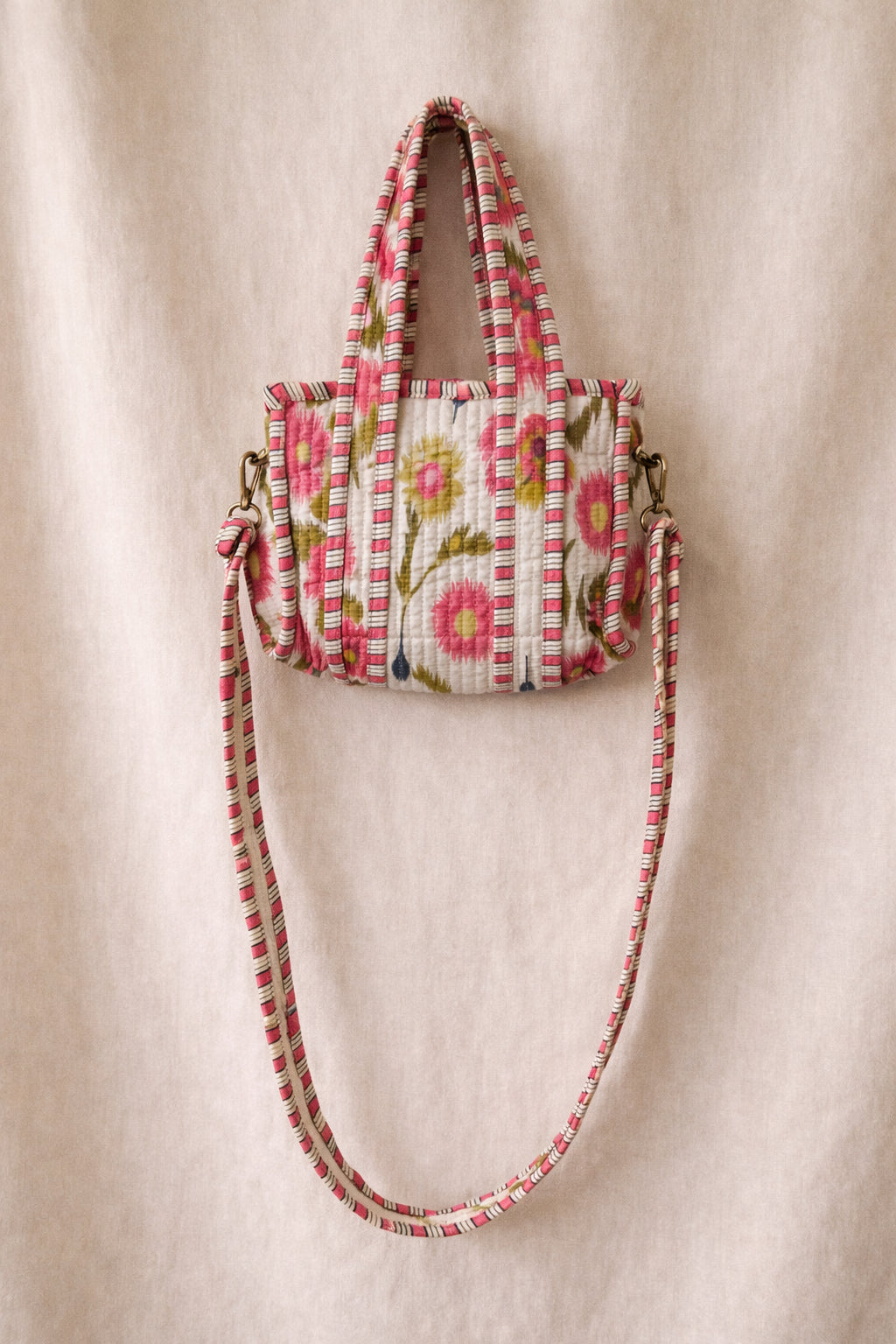 Handmade Cotton Mini Tote Bag - Lila - Wild Meadow - Arlo displayed on a wall with floral decor.