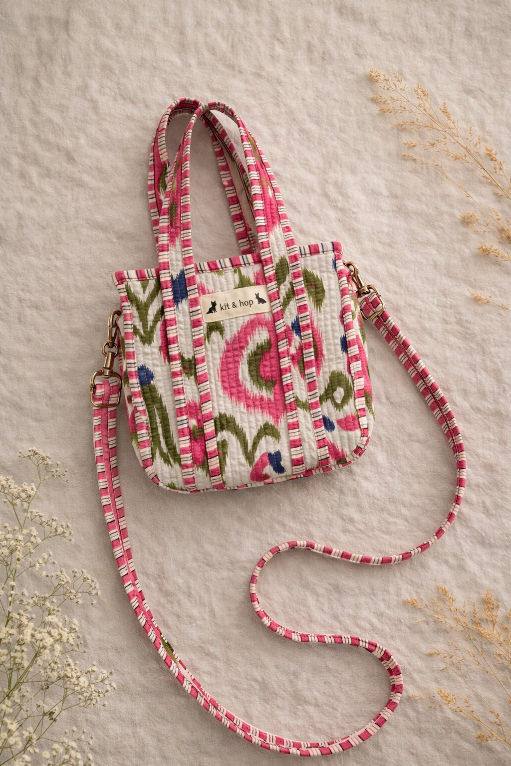 Handmade Cotton Mini Tote Bag - Lila - Wild Meadow - Arlo displayed on a wall with floral decor.