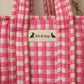 Handmade Cotton Mini Tote Bag in pink checkered pattern, hanging on a wooden hook, perfect for everyday use.