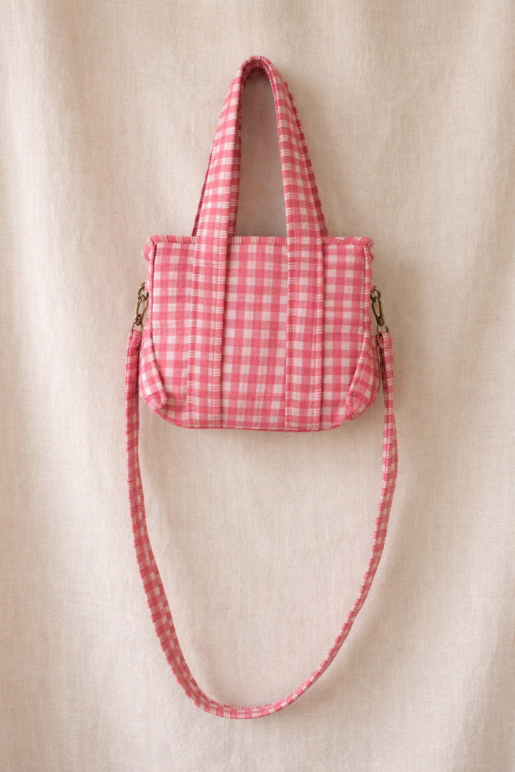 Handmade Cotton Mini Tote Bag in pink checkered pattern, hanging on a wooden hook, perfect for everyday use.