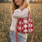Handmade Cotton Mini Tote Bag with red and white diamond pattern, hanging on a wall, showcasing its stylish design.