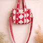 Handmade Cotton Mini Tote Bag with red and white diamond pattern, hanging on a wall, showcasing its stylish design.