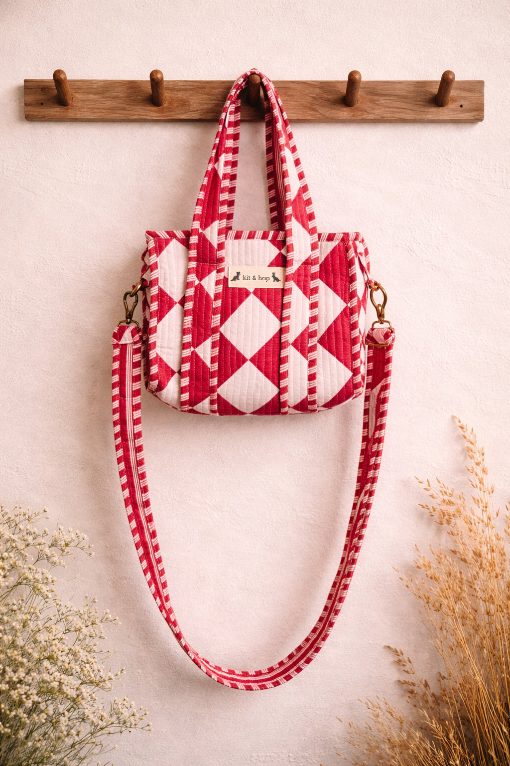 Handmade Cotton Mini Tote Bag with red and white diamond pattern, hanging on a wall, showcasing its stylish design.