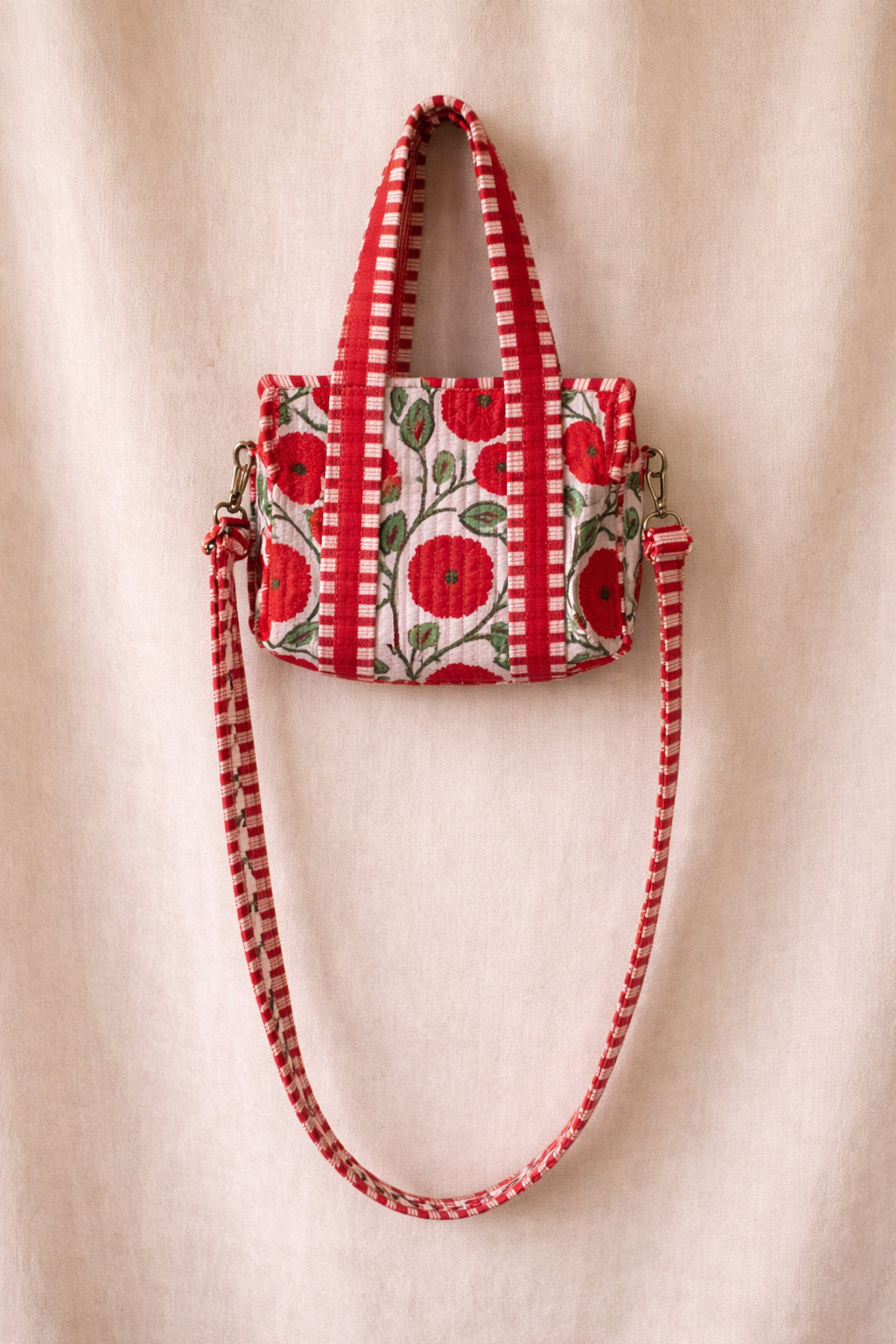 Handmade Cotton Mini Tote Bag - Lila - Wild Meadow - Poppy hanging on a wooden hook, showcasing its floral design.