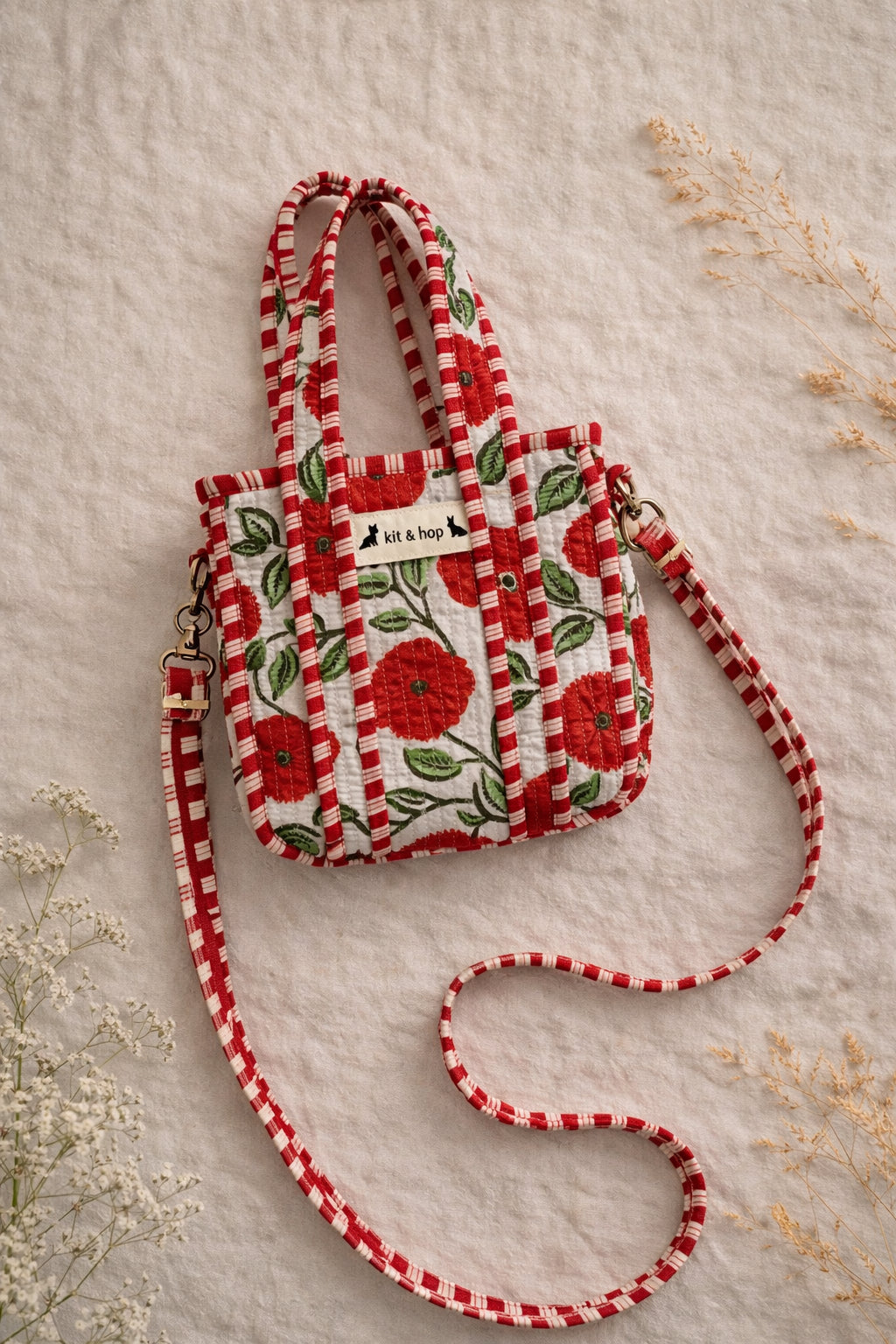 Handmade Cotton Mini Tote Bag - Lila - Wild Meadow - Poppy hanging on a wooden hook, showcasing its floral design.