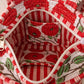 Handmade Cotton Mini Tote Bag - Lila - Wild Meadow - Poppy hanging on a wooden hook, showcasing its floral design.
