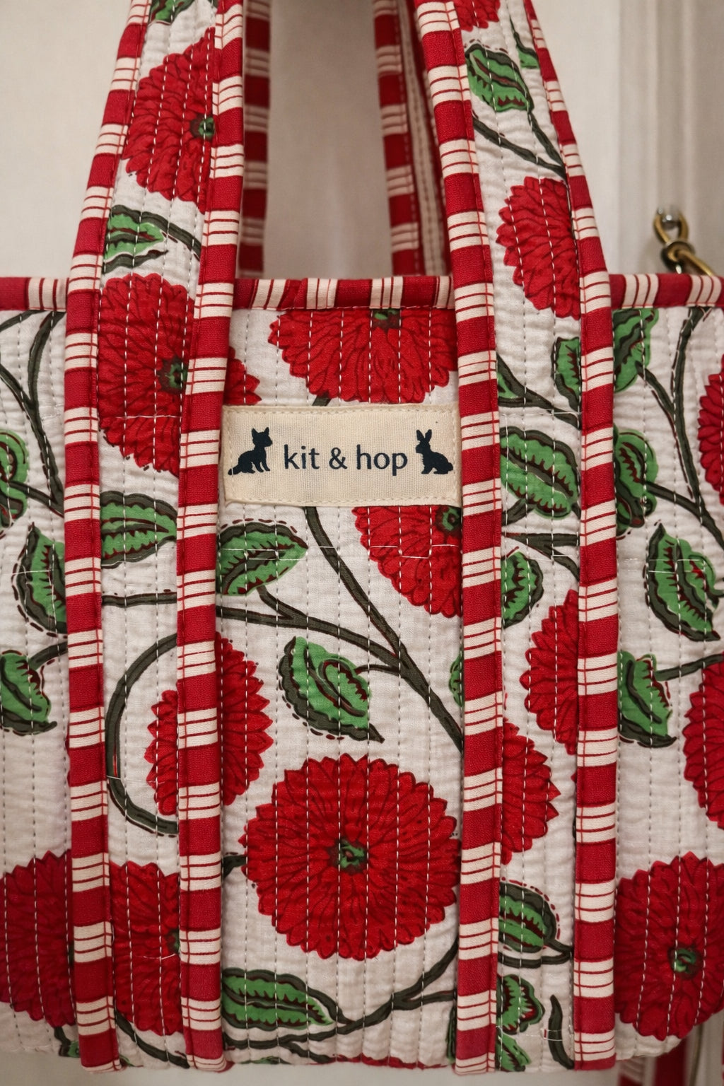 Handmade Cotton Mini Tote Bag - Lila - Wild Meadow - Poppy hanging on a wooden hook, showcasing its floral design.