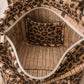 Handmade Cotton Mini Tote Bag - Lila - Wild Meadow -Sable with a stylish leopard print design, hung on a wooden hook.