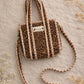 Handmade Cotton Mini Tote Bag - Lila - Wild Meadow -Sable with a stylish leopard print design, hung on a wooden hook.
