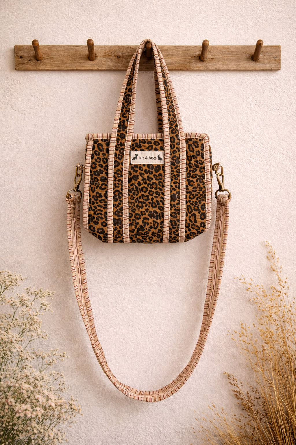Handmade Cotton Mini Tote Bag - Lila - Wild Meadow -Sable with a stylish leopard print design, hung on a wooden hook.