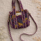 Handmade Cotton Mini Tote Bag in Wild Meadow Violet hanging on wall, perfect for everyday essentials.
