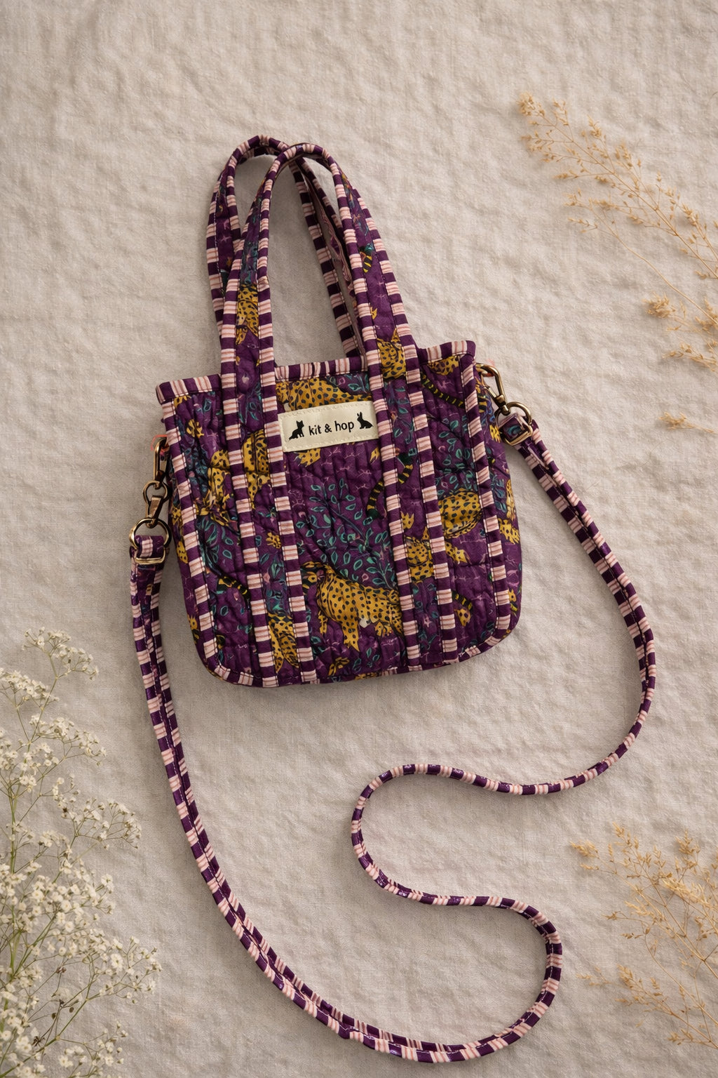 Handmade Cotton Mini Tote Bag in Wild Meadow Violet hanging on wall, perfect for everyday essentials.