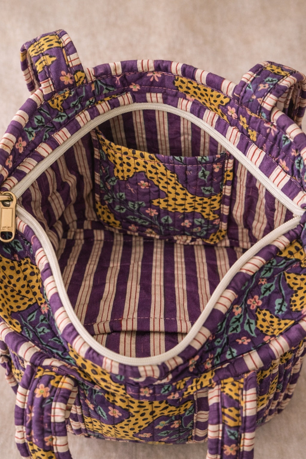 Handmade Cotton Mini Tote Bag in Wild Meadow Violet hanging on wall, perfect for everyday essentials.