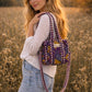 Handmade Cotton Mini Tote Bag in Wild Meadow Violet hanging on wall, perfect for everyday essentials.
