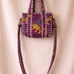 Handmade Cotton Mini Tote Bag in Wild Meadow Violet hanging on wall, perfect for everyday essentials.
