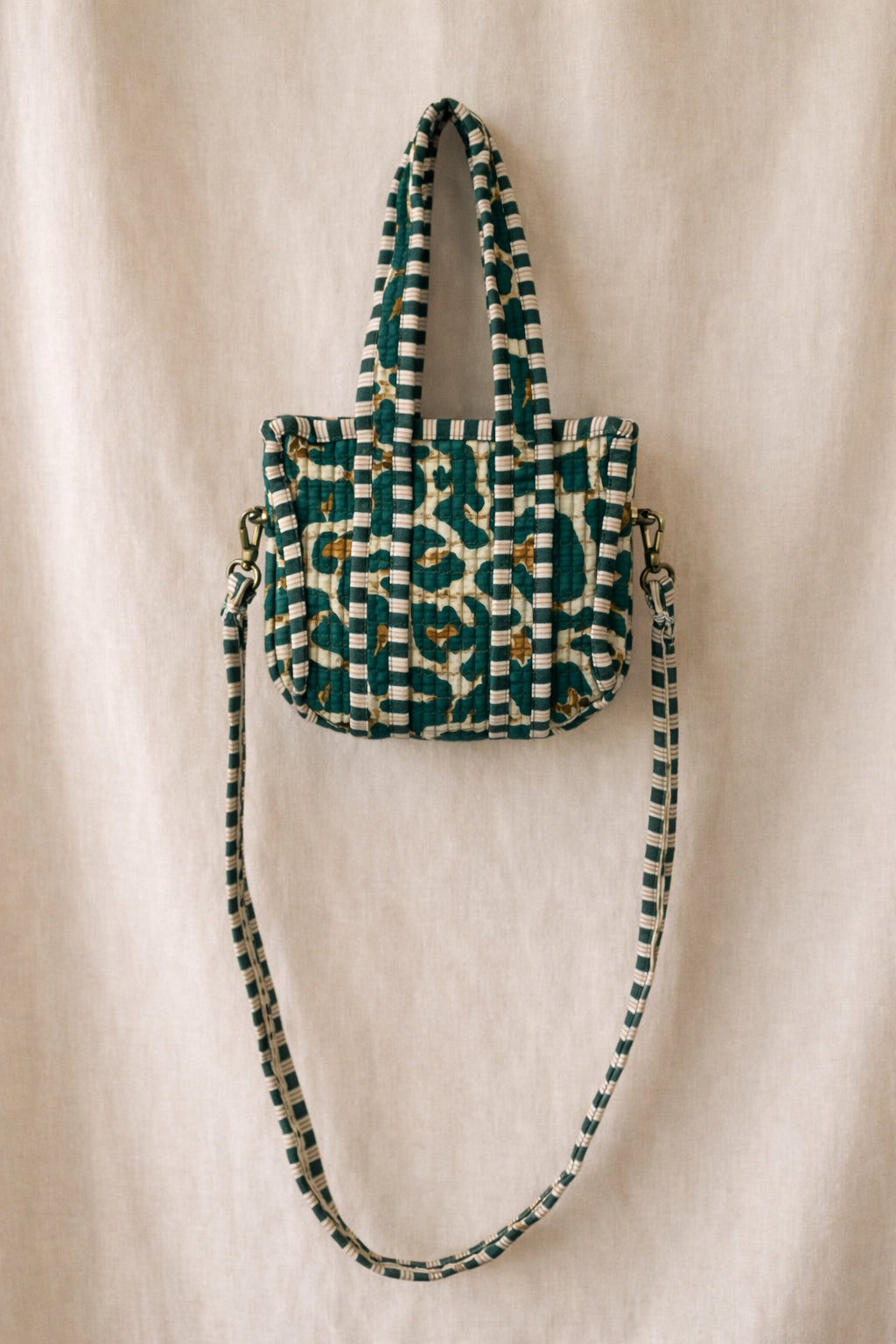 Handmade Cotton Mini Tote Bag - Lila - Wild Meadow - Olive hanging on a wooden hook with a stylish design.