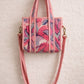 Handmade Cotton Mini Tote Bag - Lila - Wild Meadow - Paloma hanging against a wall with floral decorations.