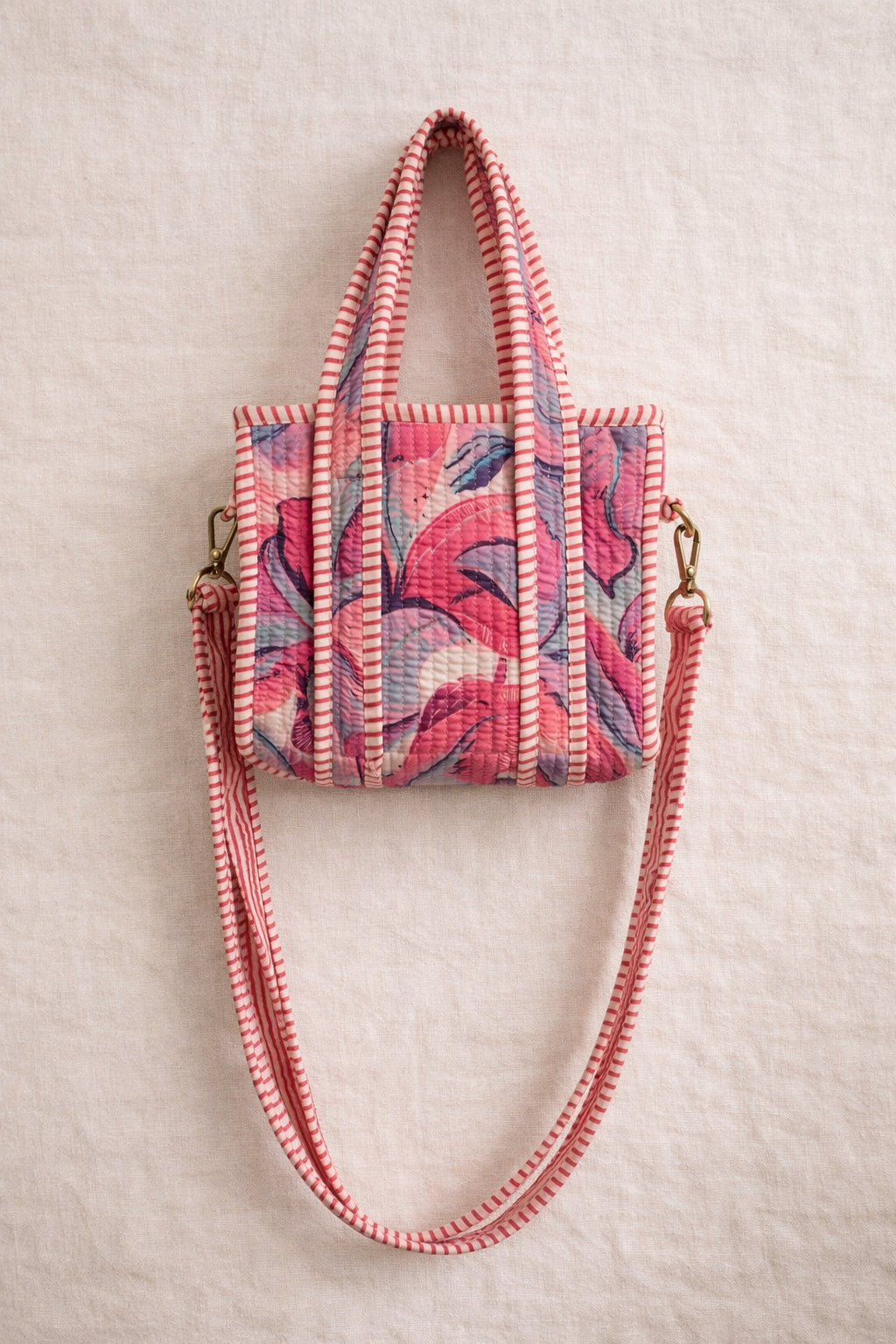 Handmade Cotton Mini Tote Bag - Lila - Wild Meadow - Paloma hanging against a wall with floral decorations.