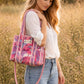 Handmade Cotton Mini Tote Bag - Lila - Wild Meadow - Paloma hanging against a wall with floral decorations.