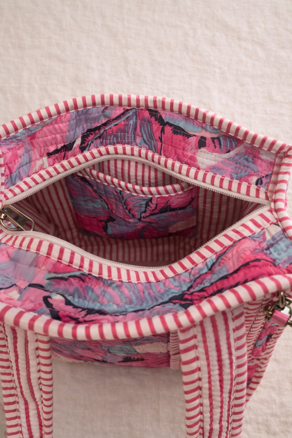 Handmade Cotton Mini Tote Bag - Lila - Wild Meadow - Paloma hanging against a wall with floral decorations.