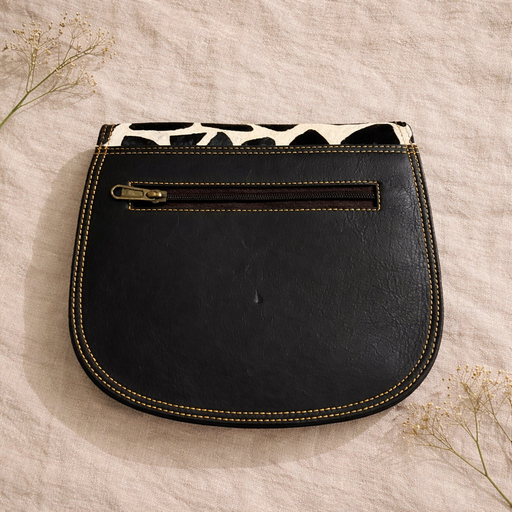 Handmade Leather Crossbody Bag in vibrant colors: green, yellow, red, and black and white print, showcasing unique design.