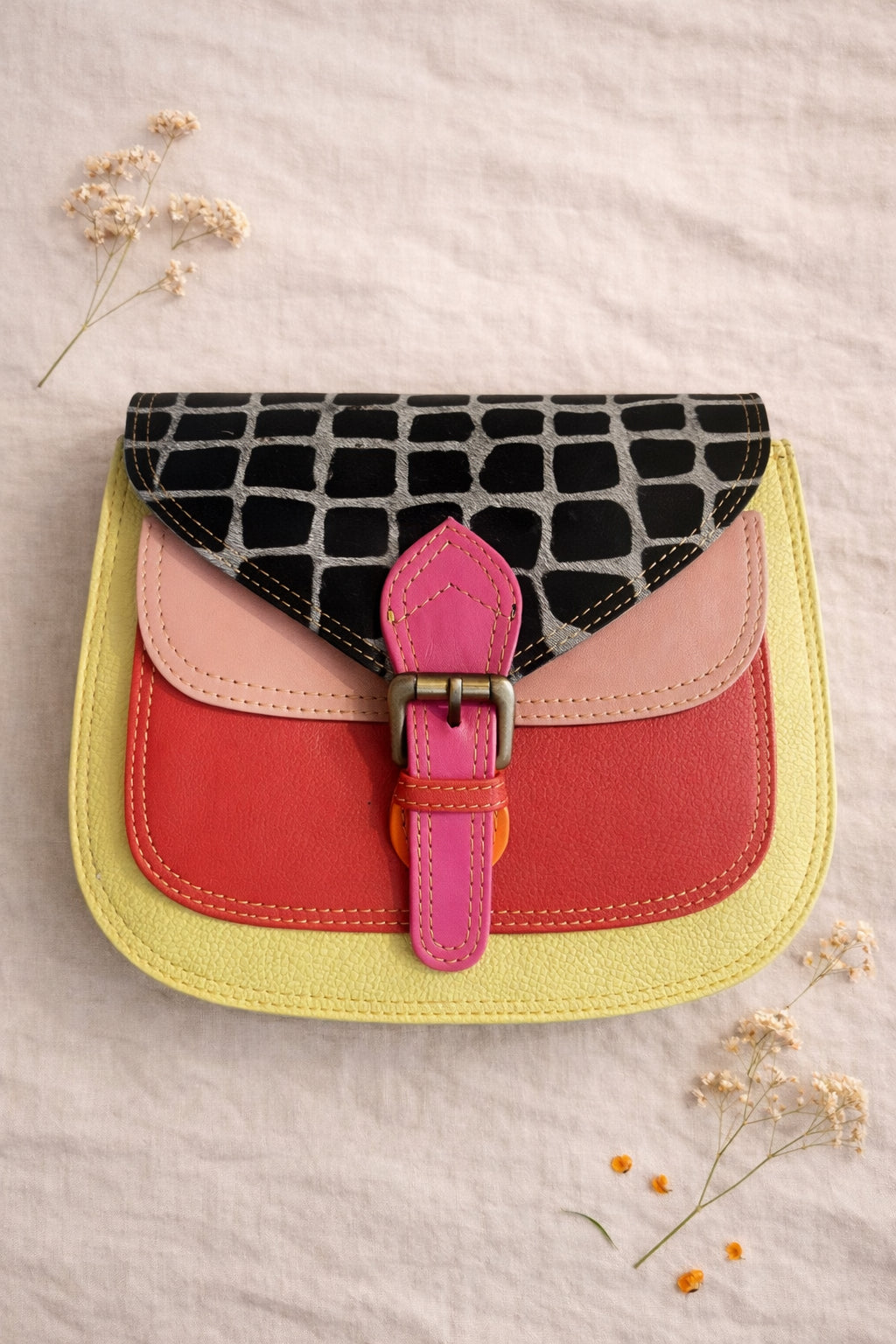 Handmade Leather Crossbody Bag in vibrant colors with unique patterns and a stylish buckle closure.