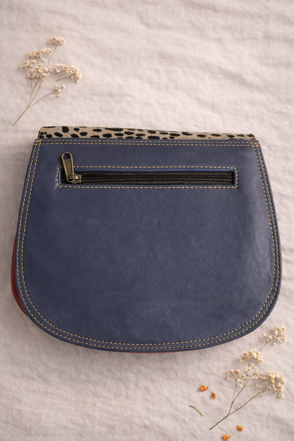 Handmade Leather Crossbody Bag in vibrant colors with unique patterns and a stylish buckle closure.