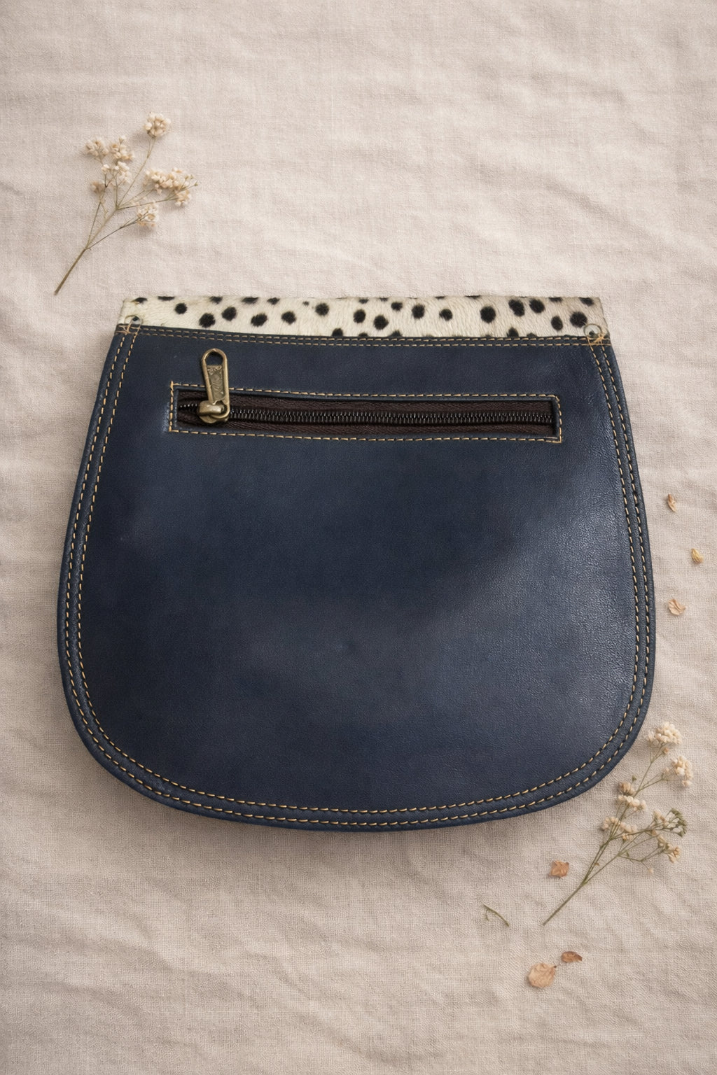 Handmade Leather Crossbody Bag - Romy in colorful leather with unique pattern and pink buckle, showcasing sustainable craftsmanship.