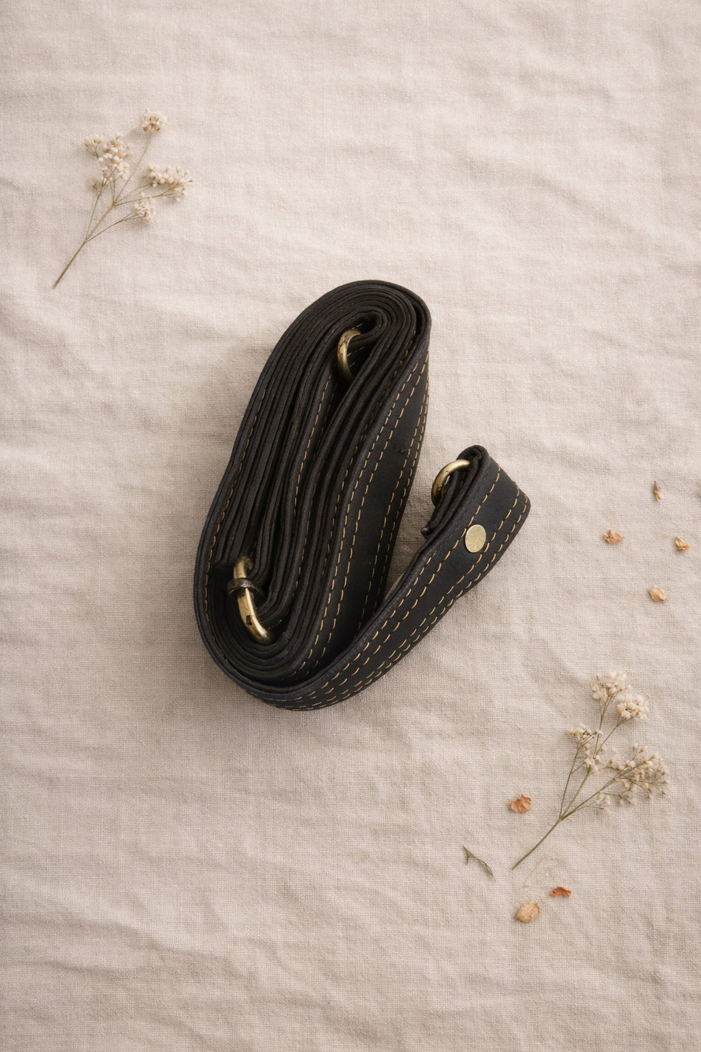 Handmade Leather Crossbody Bag - Romy in colorful leather with unique pattern and pink buckle, showcasing sustainable craftsmanship.