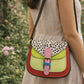 Handmade Leather Crossbody Bag - Romy in colorful leather with unique pattern and pink buckle, showcasing sustainable craftsmanship.