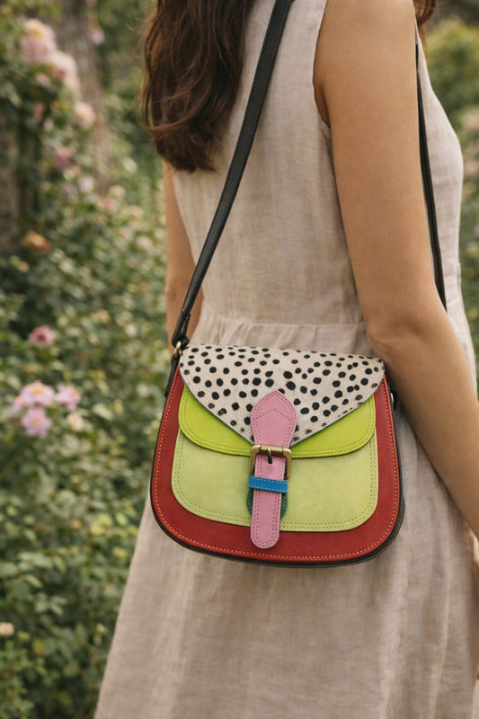 Handmade Leather Crossbody Bag - Romy in colorful leather with unique pattern and pink buckle, showcasing sustainable craftsmanship.