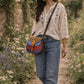 Handmade Leather Crossbody Bag - Romy in vibrant colors with leopard print flap, showcasing unique design and sustainability.