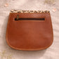 Handmade Leather Crossbody Bag in bright colors with a leopard print flap, displayed on a soft background.