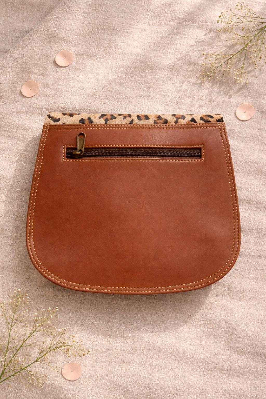 Handmade Leather Crossbody Bag in bright colors with a leopard print flap, displayed on a soft background.