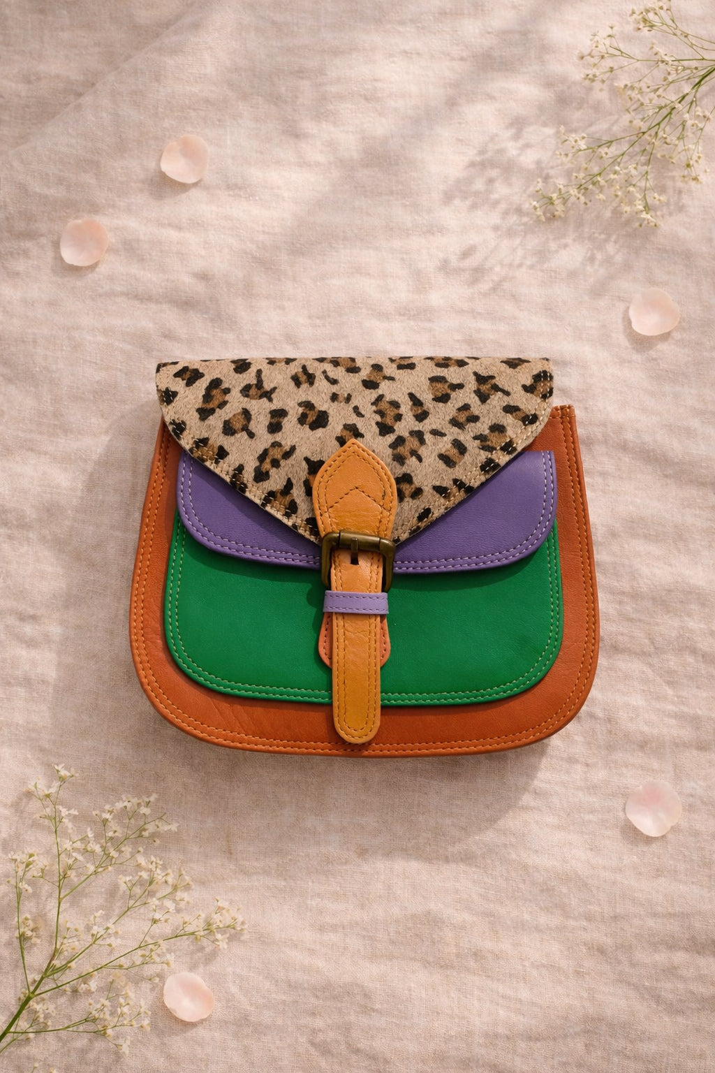 Handmade Leather Crossbody Bag in bright colors with a leopard print flap, displayed on a soft background.