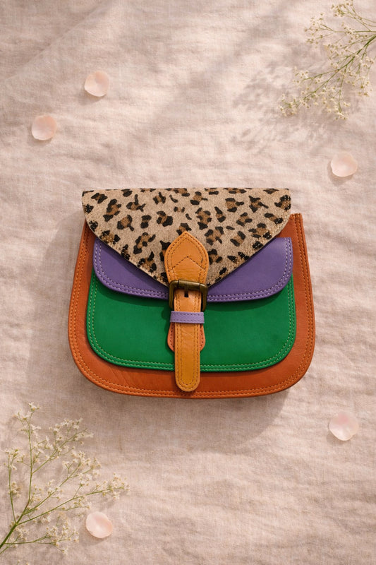 Handmade Leather Crossbody Bag in bright colors with a leopard print flap, displayed on a soft background.